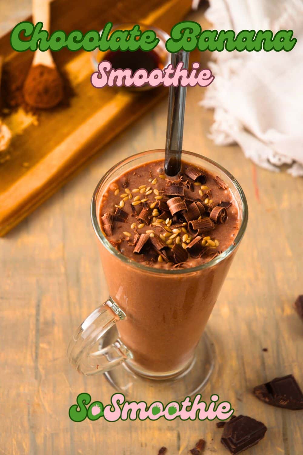 Chocolate banana smoothie in a glass topped with chocolate curls and flax seeds.