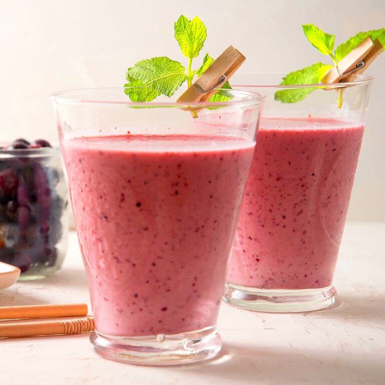 Strawberry blueberry smoothies with mint leaves.