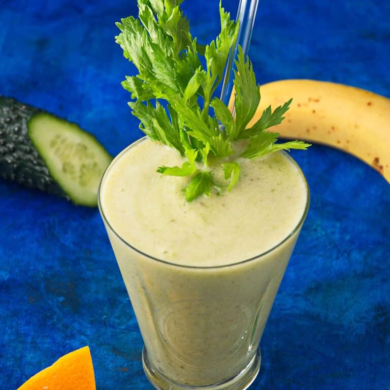Celery smoothie on blue background.