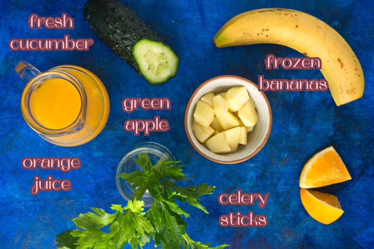 Celery smoothie ingredients prepped on blue background.