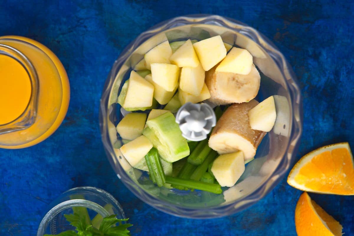Celery smoothie ingredients in food processor.