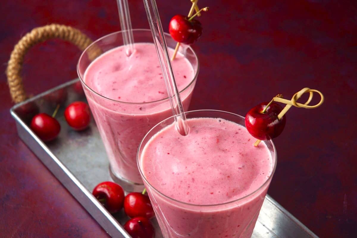 Cherry smoothies on metal serving dish.