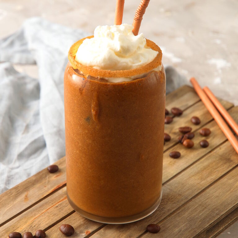 Coffee smooth with whipped cream topping in glass.