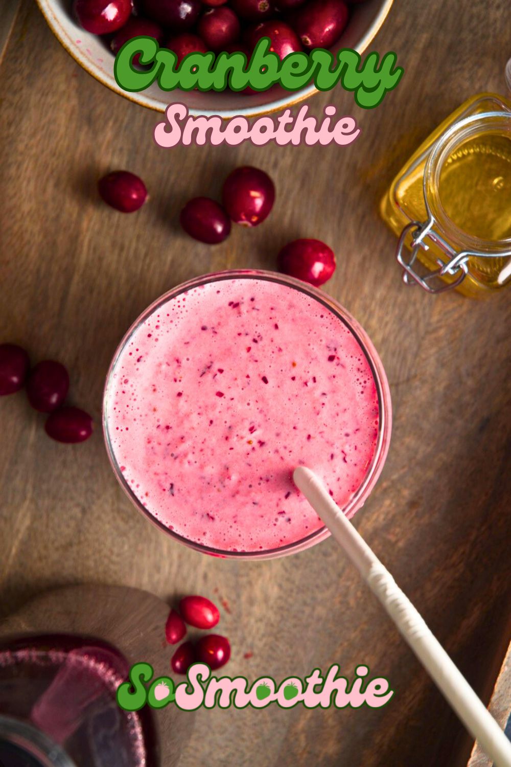 Cranberry smoothie in glass with cranberries on the side and text overlay that says 'Cranberry Smoothie - Sosmoothie'.