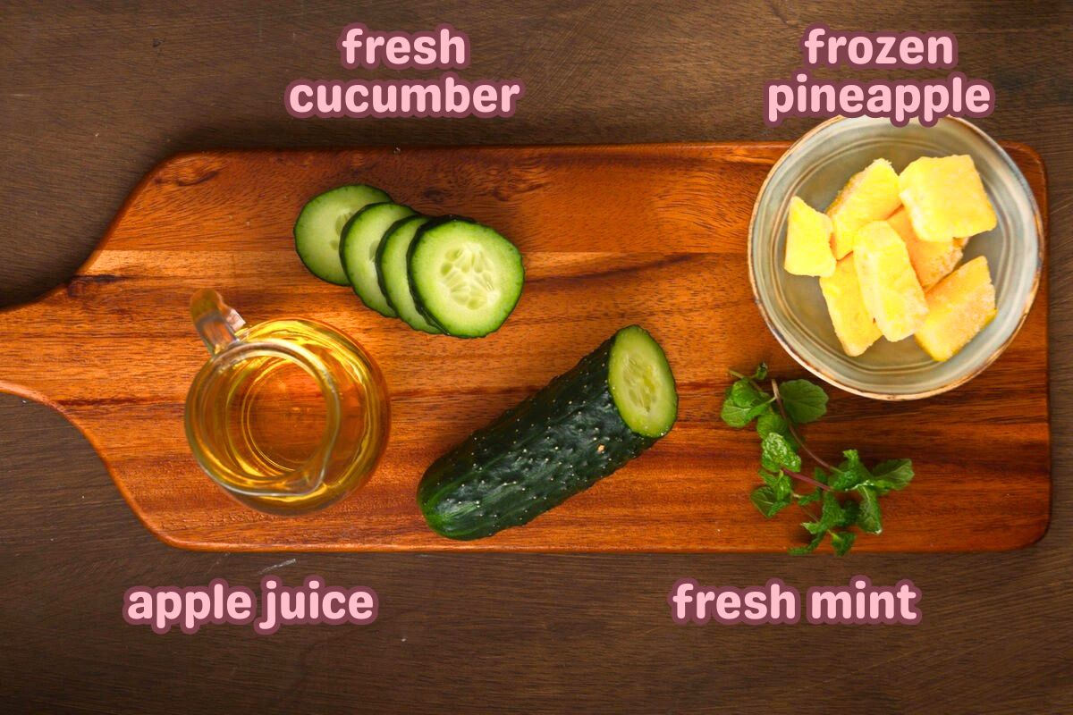 Cucumber smoothie ingredients prepped and labeled on wooden board.