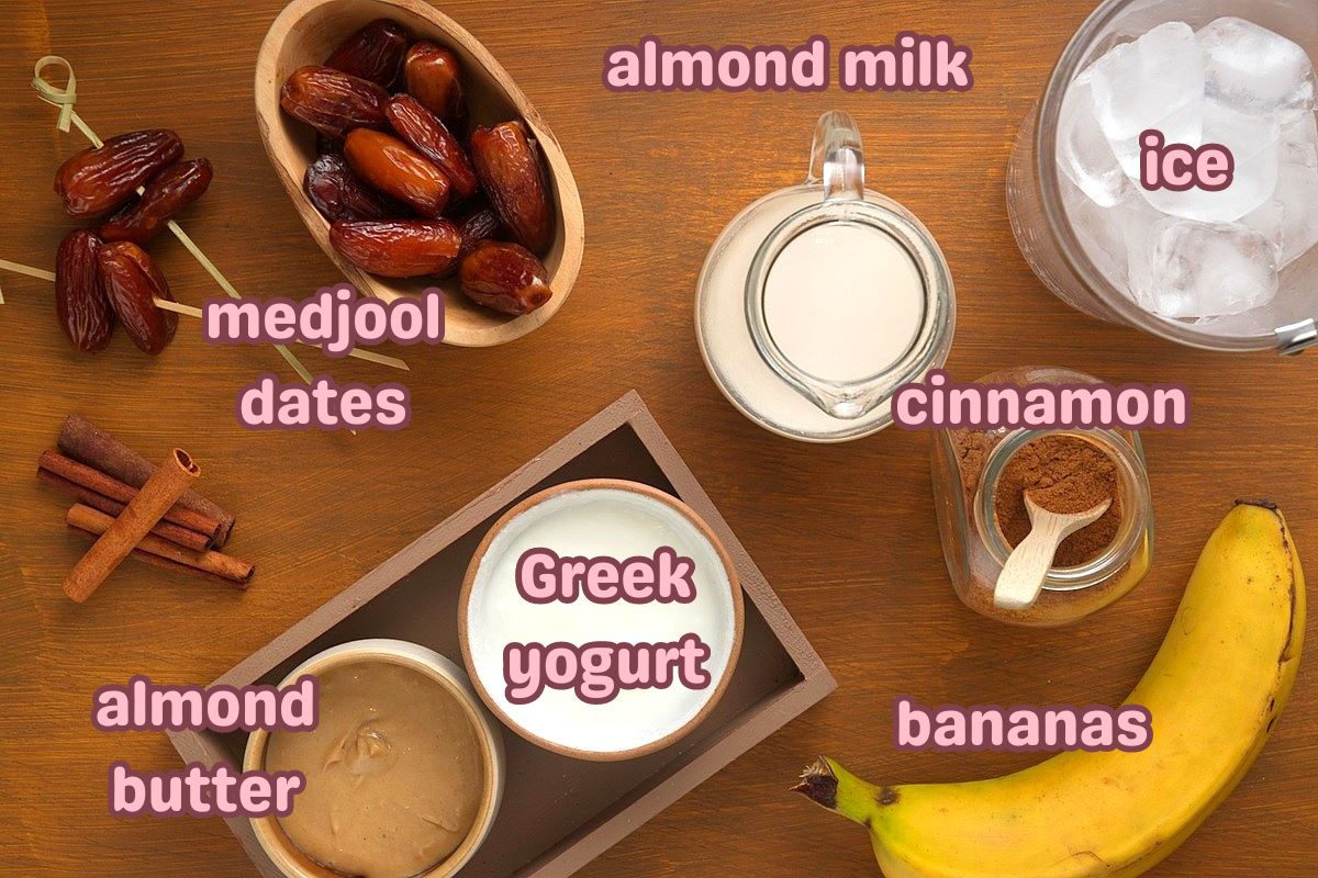 Date smoothie ingredients prepped on brown background.