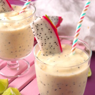 Dragon fruit smoothie in glasses with straws.