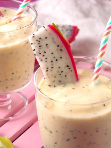 Dragon fruit smoothie in glasses with straws.