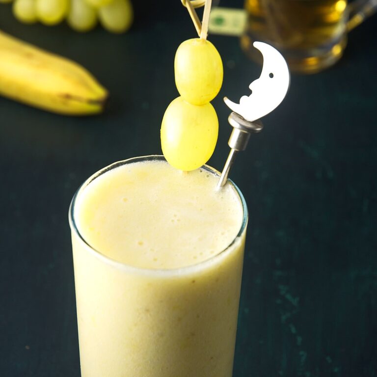Green tea smoothie in tall glass.