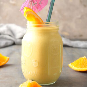 Mango pineapple smoothie in jar.